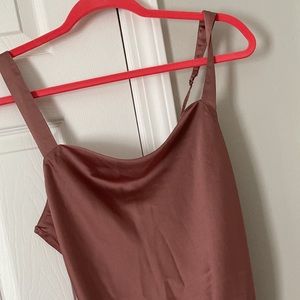 Pink satin body suit.